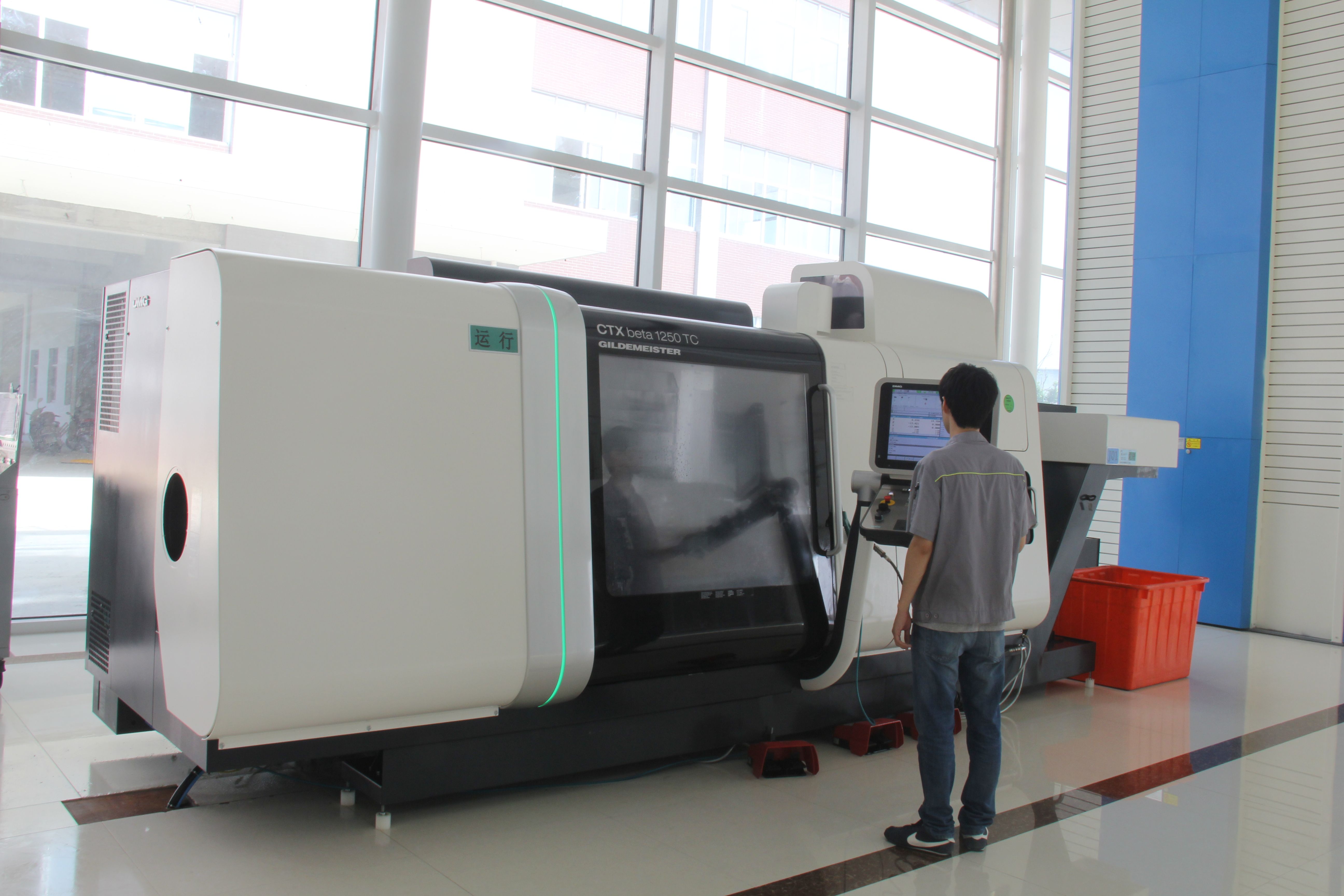 A machinist operating a DMG CTX beta 1250 TC turn-mill centre at Kangli