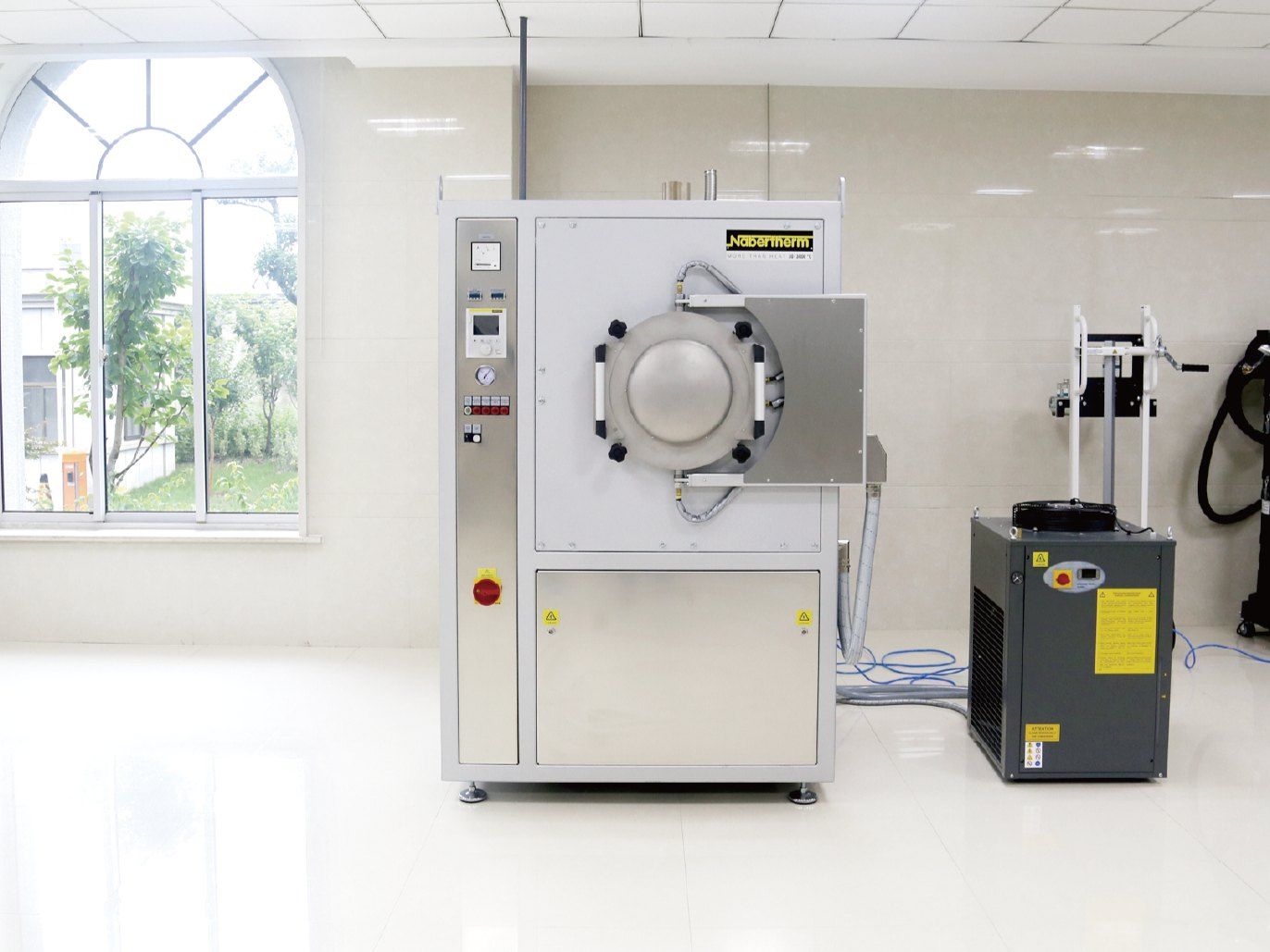 Nabertherm vacuum heat-treatment furnace and chiller unit in a clean, tiled room at Kangli